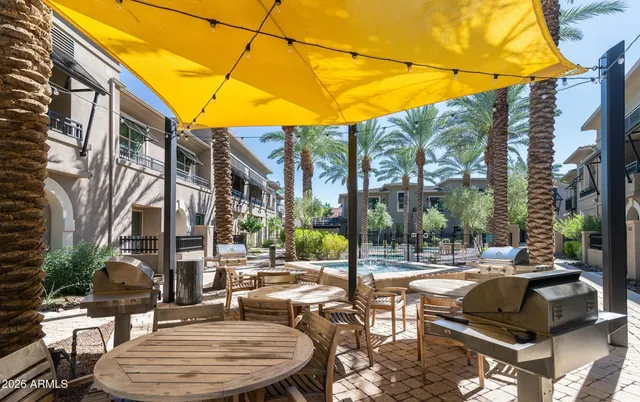 a swimming pool with outdoor seating and yard