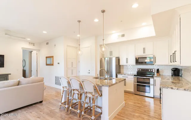 a large kitchen with stainless steel appliances