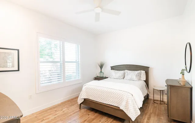 a bedroom with a bed and a large window