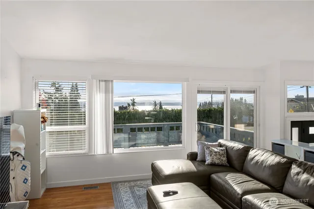 a living room with furniture and a floor to ceiling window