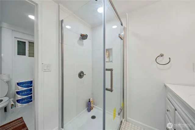 a bathroom with a shower and a sink