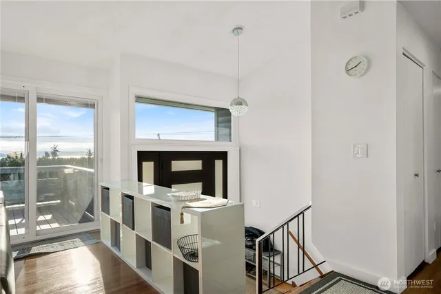 a view of an entryway with wooden floor