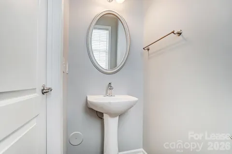 a bathroom with a sink a mirror and a window