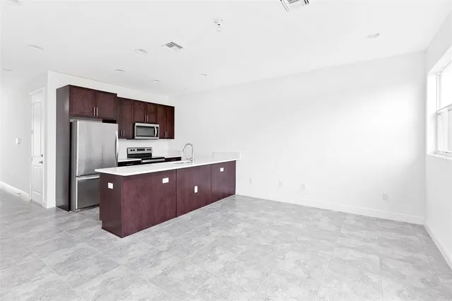 a kitchen with a refrigerator stove and microwave