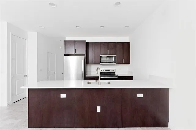 a kitchen with stainless steel appliances a refrigerator and a stove