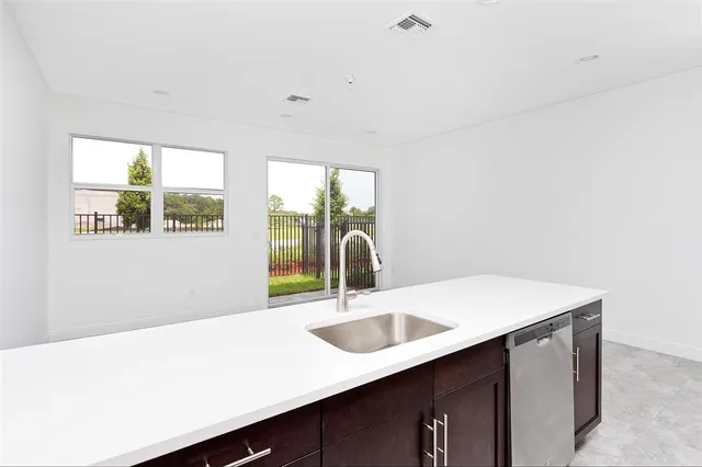 a close view of a sink and a cabinet in a room