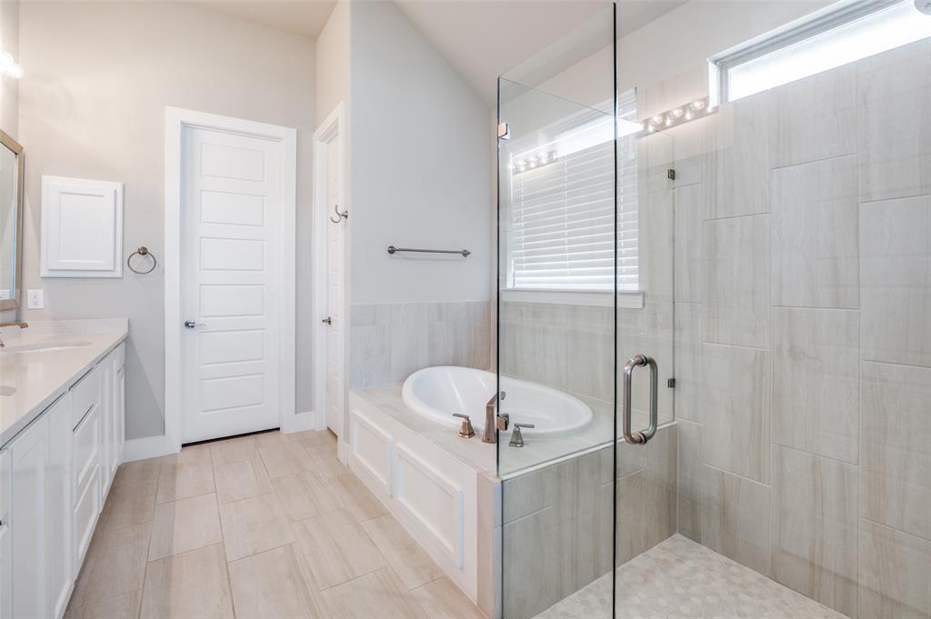 2901 Quinton Street Prosper, TX 75078 - Photo 15 of 27 a bathroom with a tub shower sink and mirror