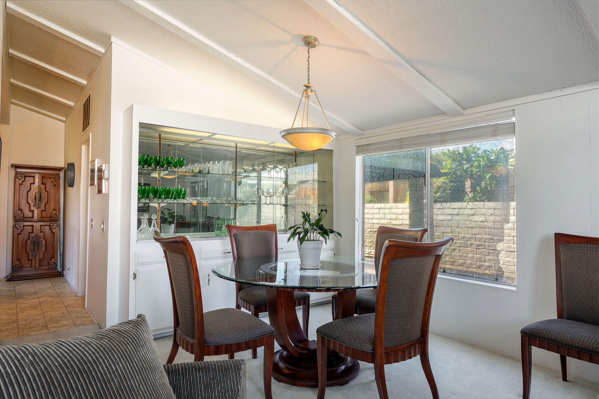 149 Capri Street Rancho Mirage, CA 92270 - Photo 12 of 50 a dining room with furniture a chandelier and wooden floor
