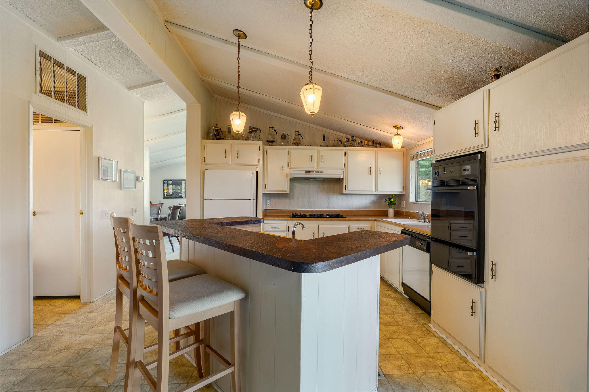 149 Capri Street Rancho Mirage, CA 92270 - Photo 16 of 50 a kitchen with stainless steel appliances granite countertop a sink a stove and a refrigerator