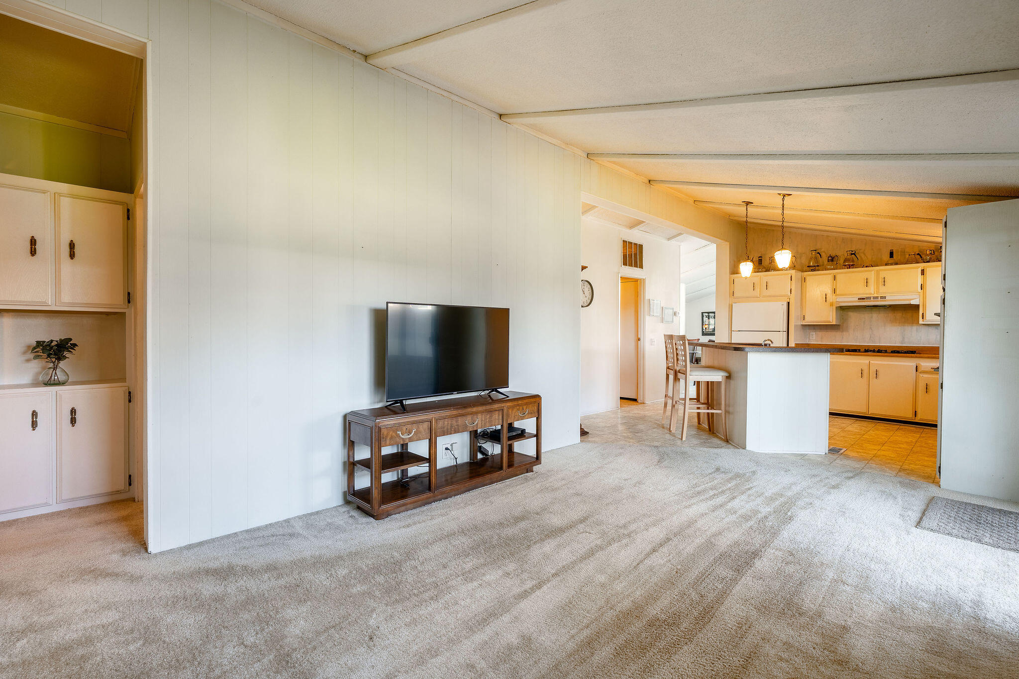 149 Capri Street Rancho Mirage, CA 92270 - Photo 18 of 50 a living room with furniture and a flat screen tv