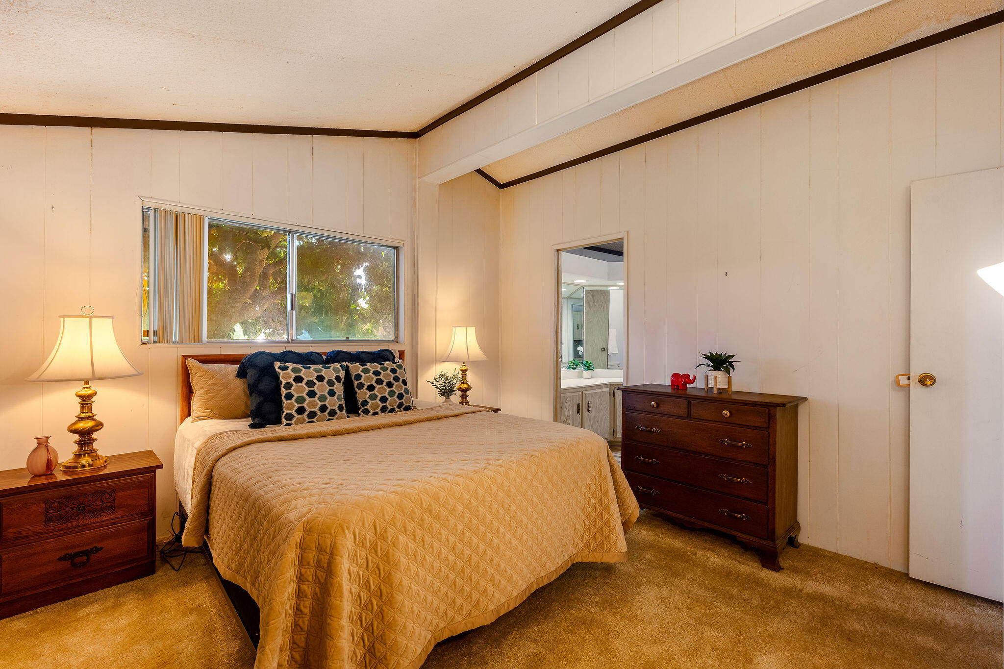 149 Capri Street Rancho Mirage, CA 92270 - Photo 25 of 50 a spacious bedroom with a bed and a dresser