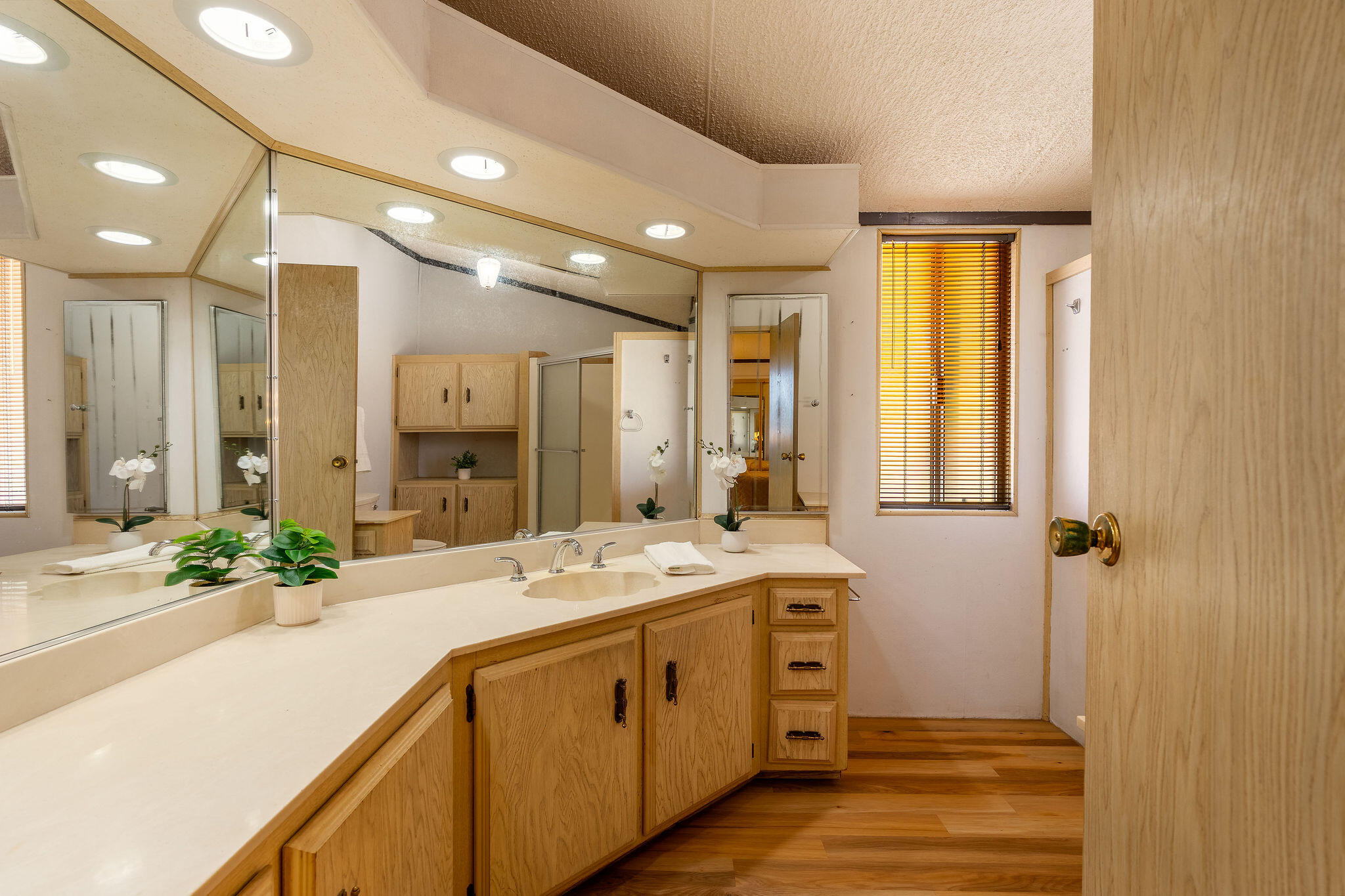 149 Capri Street Rancho Mirage, CA 92270 - Photo 26 of 50 a spacious bathroom with a double vanity sink a large mirror and shower