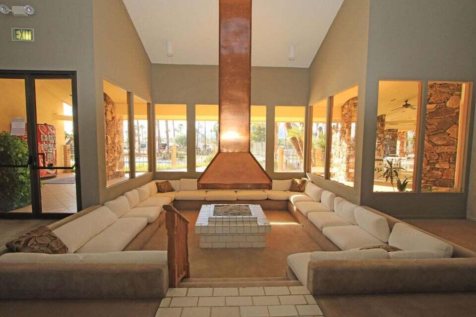 149 Capri Street Rancho Mirage, CA 92270 - Photo 38 of 50 a living room with furniture and large windows