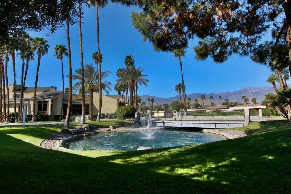 149 Capri Street Rancho Mirage, CA 92270 - Photo 49 of 50 a view of a lake with palm trees