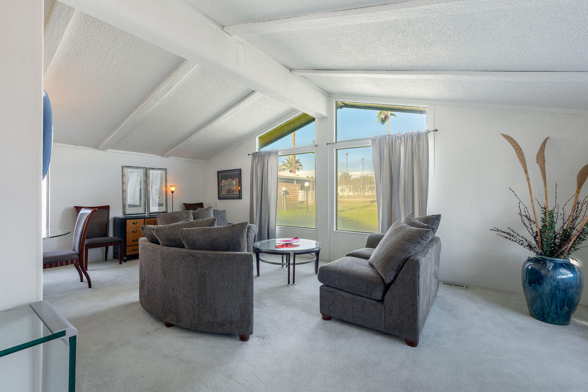 149 Capri Street Rancho Mirage, CA 92270 - Photo 7 of 50 a living room with furniture and a large window