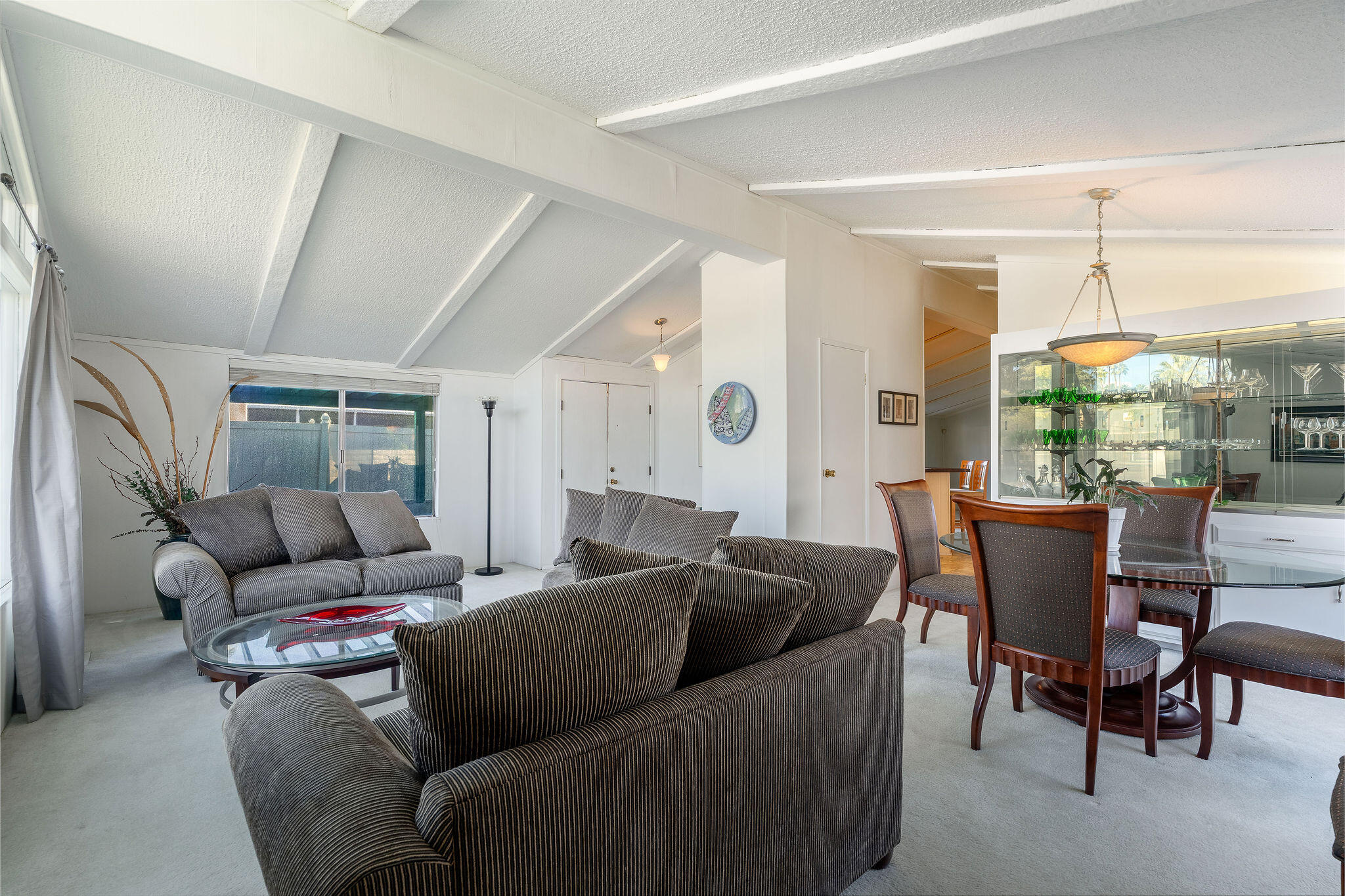 149 Capri Street Rancho Mirage, CA 92270 - Photo 8 of 50 a living room with furniture and a large window