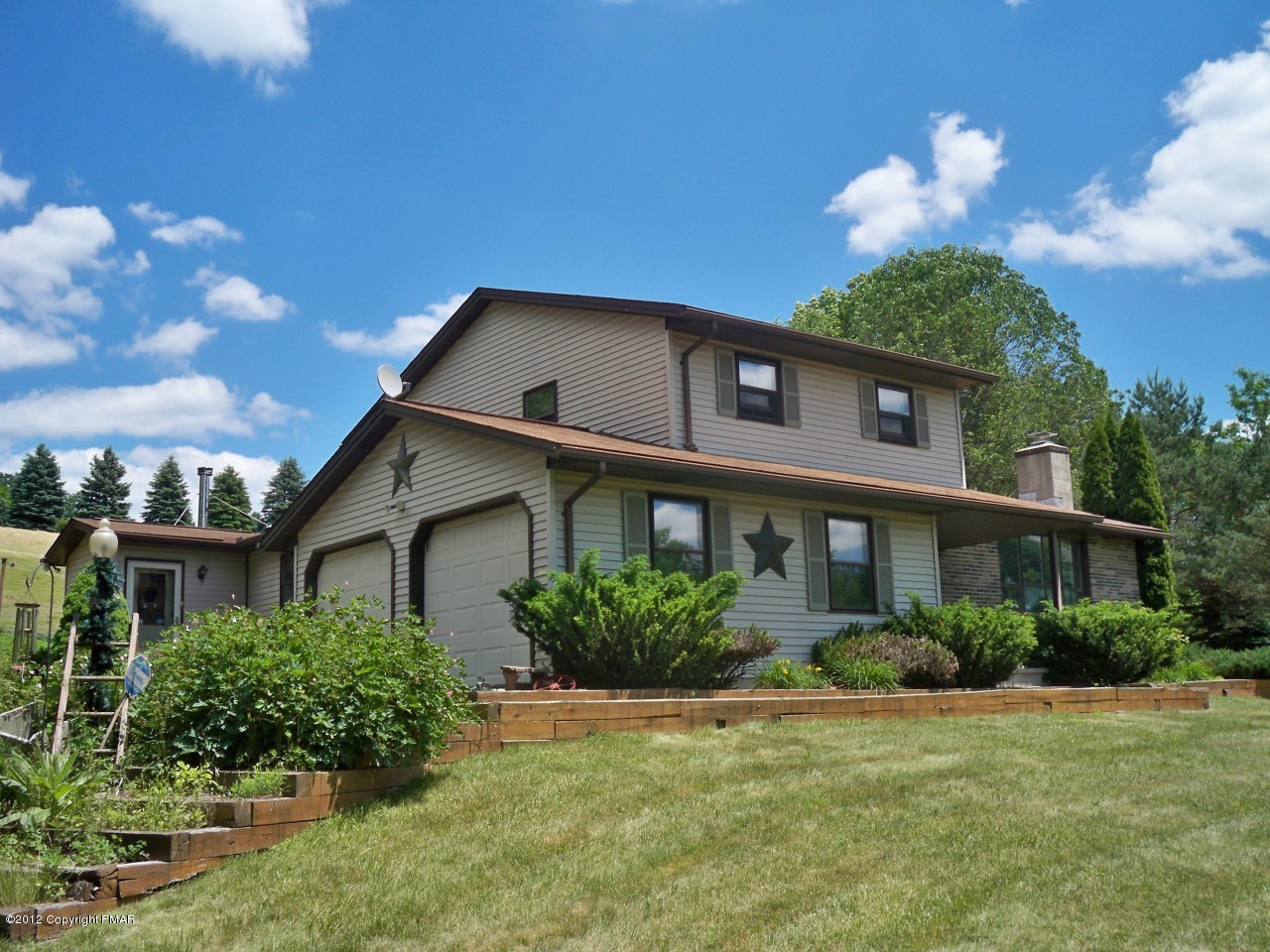 a front view of a house with garden