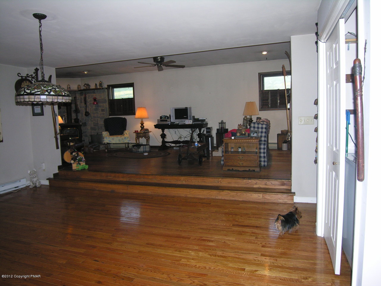 5720 Neola Road Stroudsburg, PA 18360 - Photo 9 of 16 a living room with fireplace furniture and a chandelier