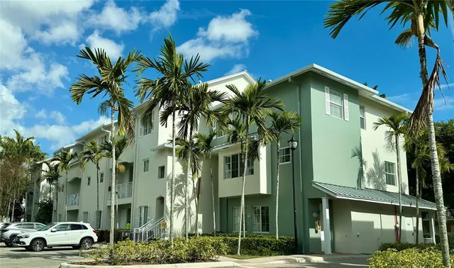 a view of a street with palm trees