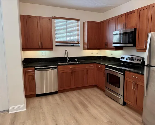 a kitchen with a sink stove and microwave
