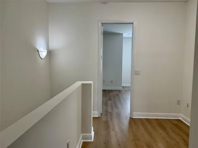 a view of hallway with wooden floor