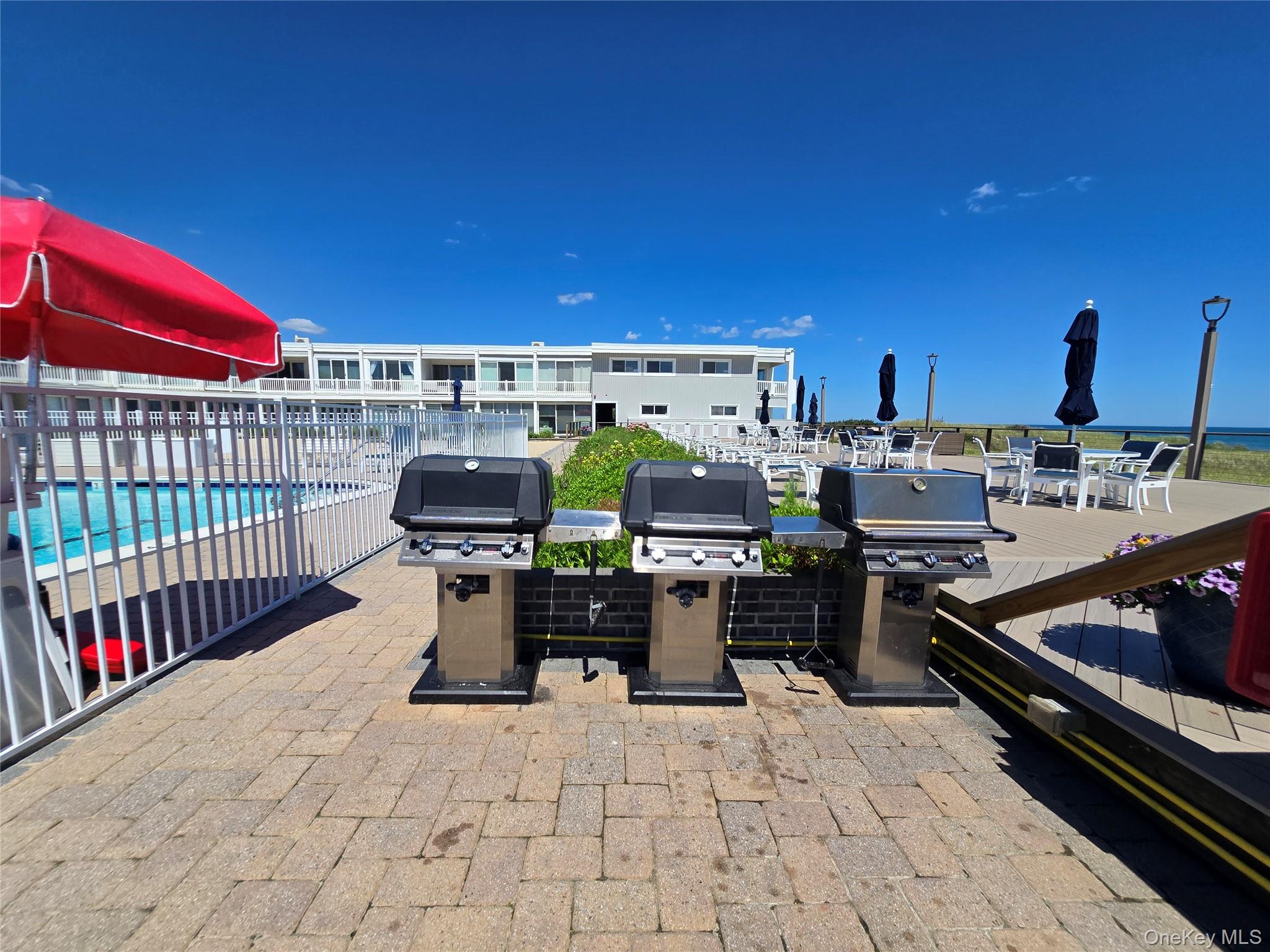 585 Dune Road, Unit L10 Westhampton, NY 11978 - Photo 6 of 25 Outdoor grilling station featuring three gas grills on a paver patio