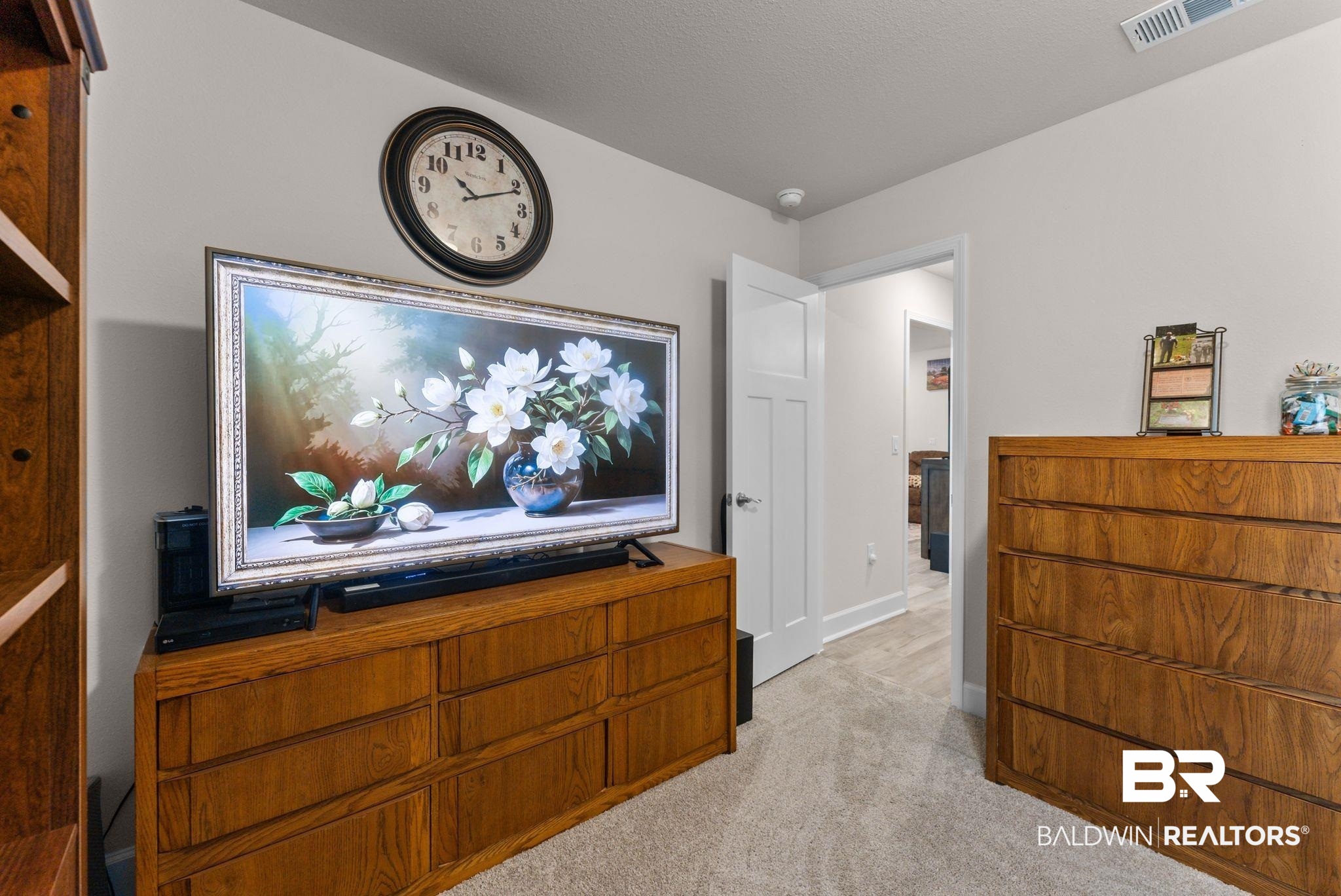 692 Mayflower Drive Foley, AL 36535 - Photo 19 of 40 Living area with light carpet and baseboards