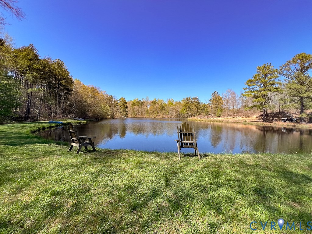 18262 Seals Road Bowling Green, VA 22427 - Photo 36 of 50 a backyard of a house with table and chairs