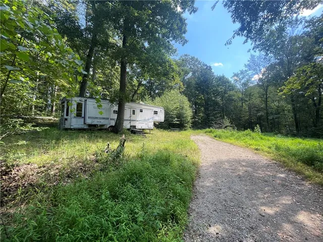 a view of a lake with house next to a yard