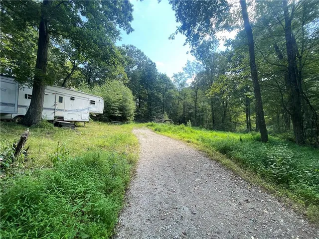 a backyard of a house with yard and trampoline