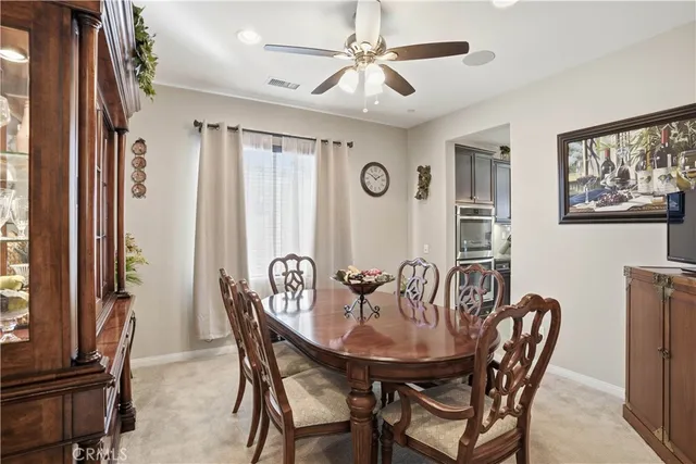 a living room with furniture ceiling fan and a window