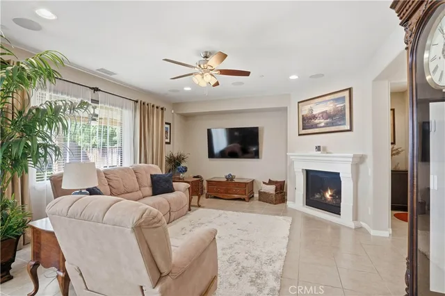 a kitchen with kitchen island granite countertop a table chairs microwave and refrigerator