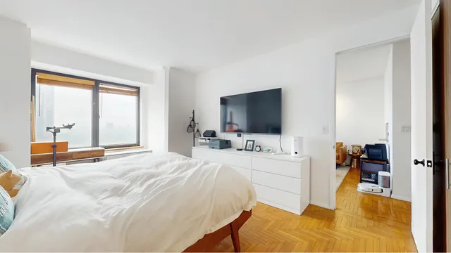 a bedroom with a bed and a window