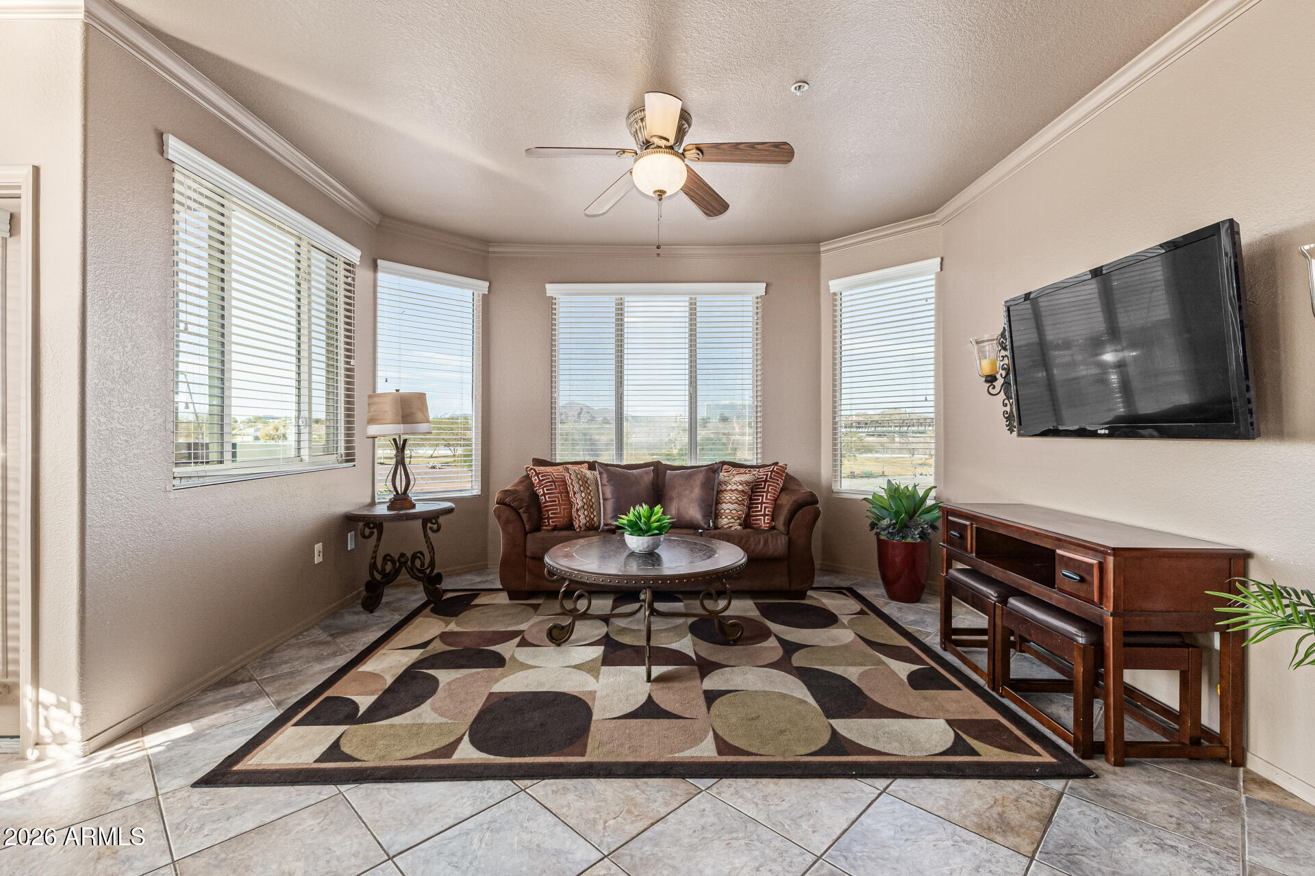 425 West Rio Salado Parkway, Unit 101 Tempe, AZ 85281 - Photo 7 of 32 a living room with furniture a flat screen tv and a window