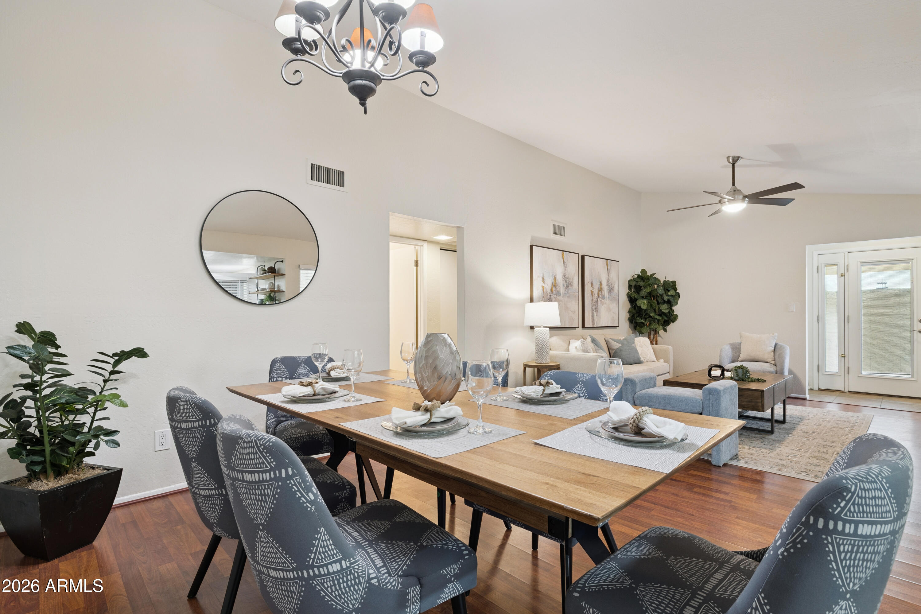4343 East Osborn Road Phoenix, AZ 85018 - Photo 5 of 41 a view of a dining room with furniture a chandelier and wooden floor