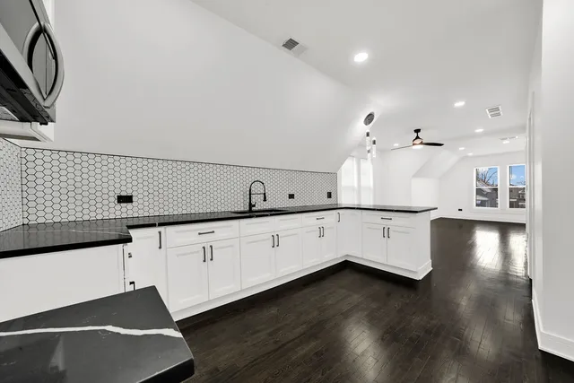 a large white kitchen with lots of counter space
