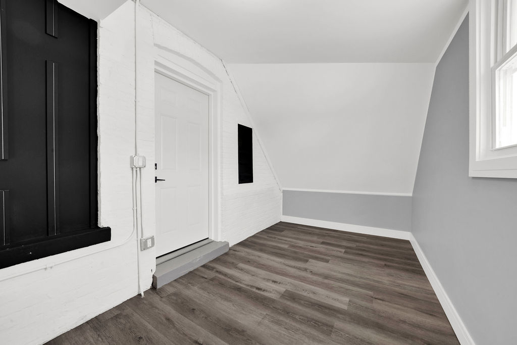 6607 South Oakley Avenue Chicago, IL 60636 - Photo 19 of 32 a view of a hallway with wooden floor and a window