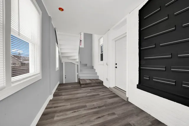 a view of an entryway with wooden floor