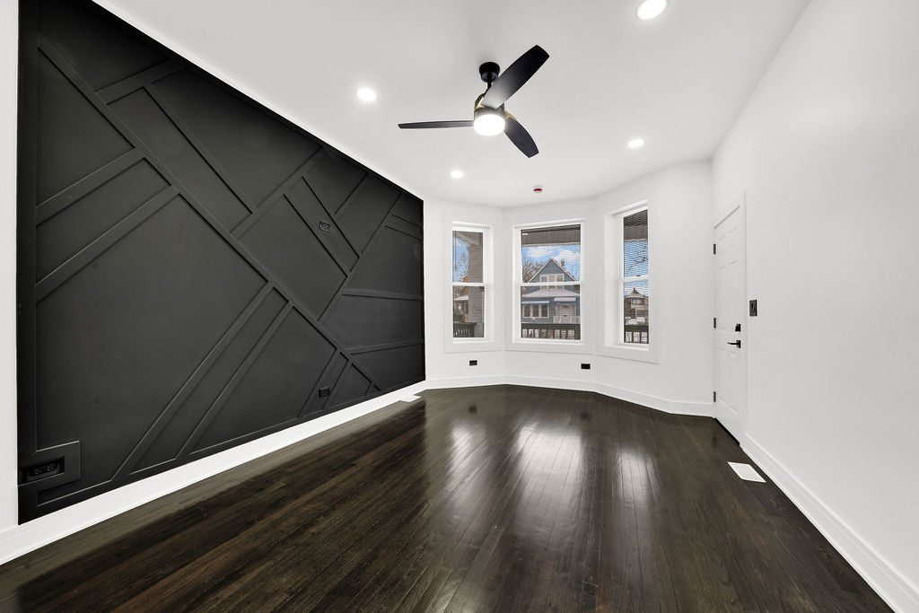 6607 South Oakley Avenue Chicago, IL 60636 - Photo 3 of 32 a view of an empty room with wooden floor and a window
