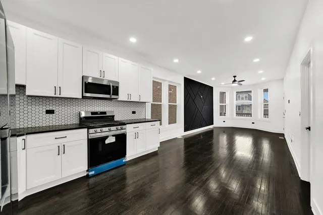 a view of kitchen with wooden floor and electronic appliances