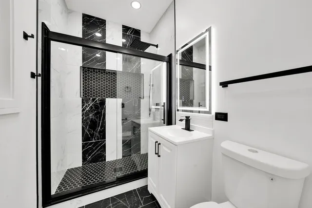 a bathroom with a sink toilet and shower