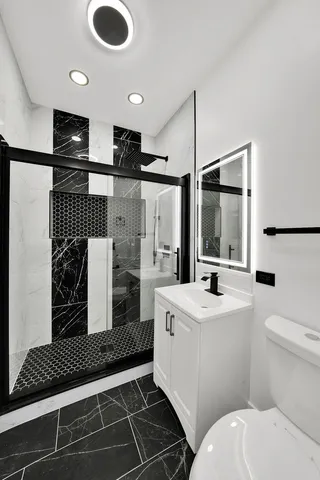 a bathroom with a sink toilet and shower