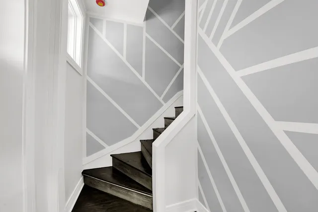 a view of staircase with white walls and a window