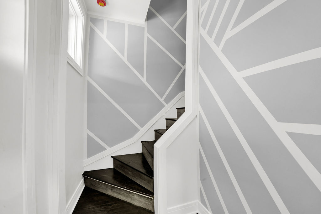 6607 South Oakley Avenue Chicago, IL 60636 - Photo 10 of 32 a view of staircase with white walls and a window