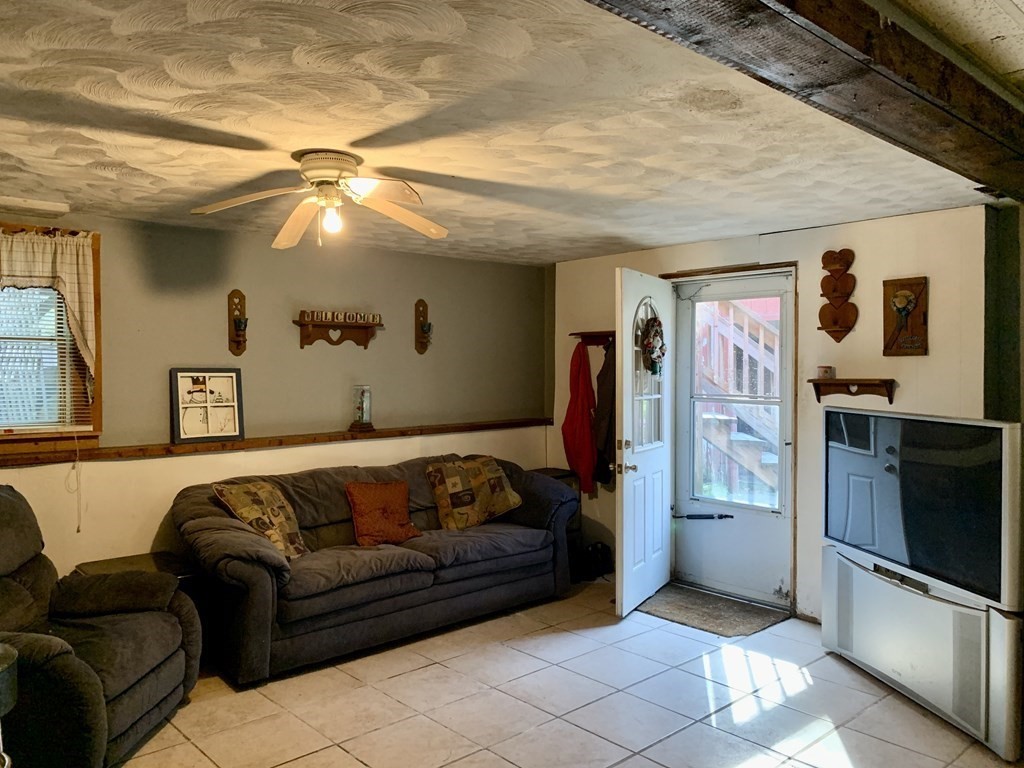 11 Hebert Road Spencer, MA 01562 - Photo 16 of 29 a living room with furniture and a flat screen tv