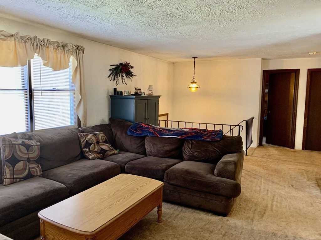 11 Hebert Road Spencer, MA 01562 - Photo 9 of 29 a living room with furniture and a flat screen tv