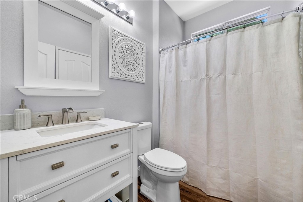 11499 Bridgeway Drive Riverside, CA 92505 - Photo 24 of 70 a bathroom with a sink a toilet and a mirror