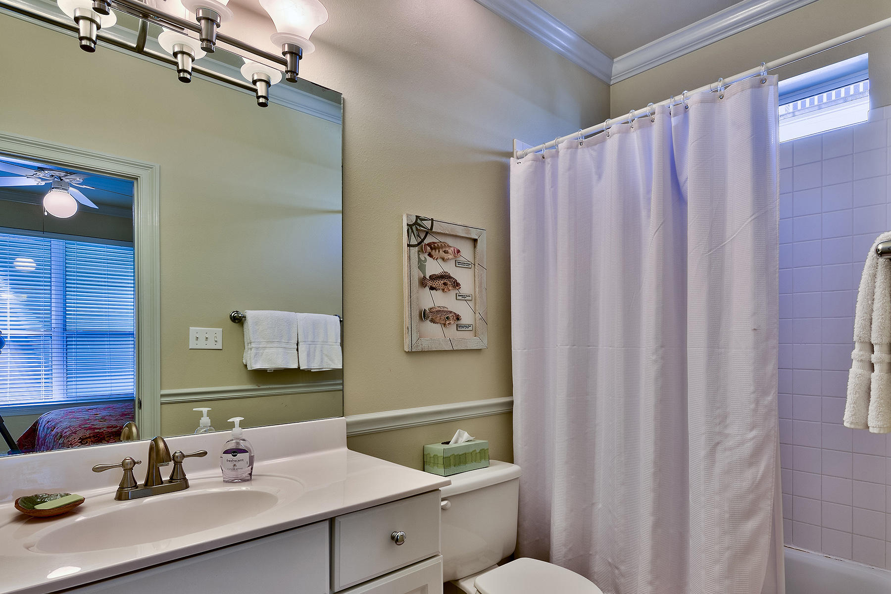 49 Cottage Street Santa Rosa Beach, FL 32459 - Photo 23 of 27 a bathroom with a sink a toilet and shower curtain