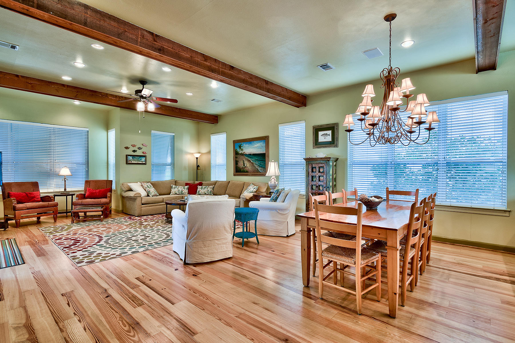 49 Cottage Street Santa Rosa Beach, FL 32459 - Photo 3 of 27 a dining room with wooden floor a chandelier a wooden table and chairs