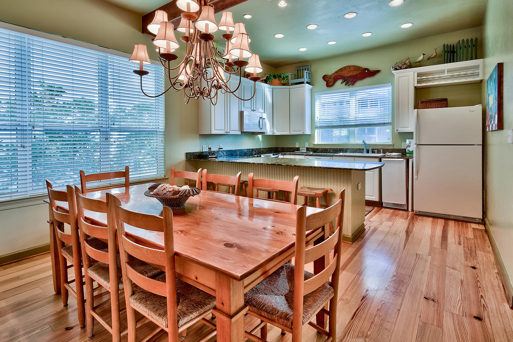 49 Cottage Street Santa Rosa Beach, FL 32459 - Photo 8 of 27 a kitchen with a table chairs refrigerator and microwave